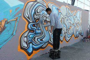 Painting graffiti at Bondi beach 