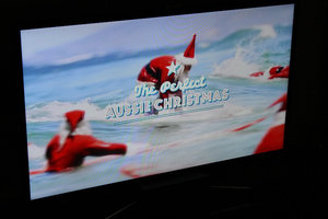 An ad on TV - Santa Claus surfing