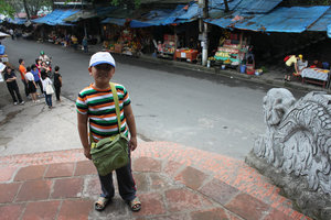 My nephew Nam in front of Cửa Ông temple