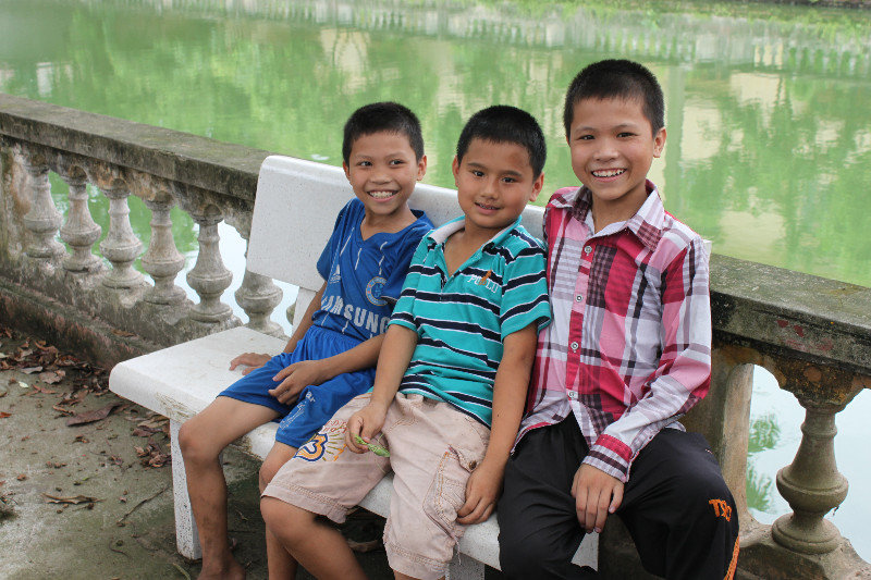 Young boys by a pond in Đông Hồ village