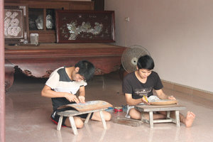 Boys carving on wood