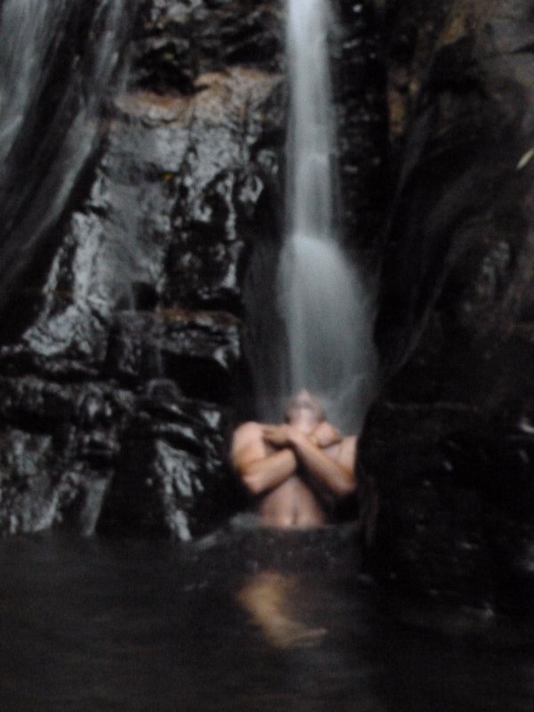 Taking a shower at a waterfall in Parque Nacional da Tijuca