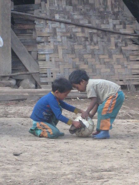 Children cleaning dung off the football!
