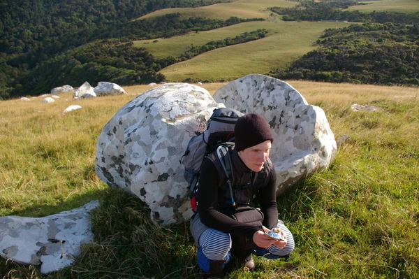Eva next to lichen covered boulder
