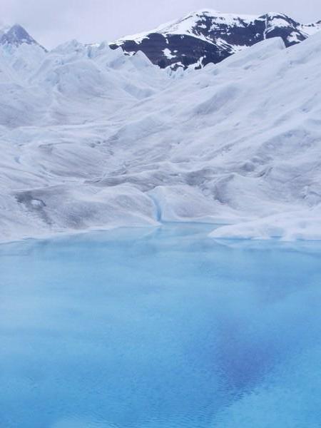 Electric blue lake in the ice wilderness