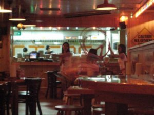 Hooters in Singapore!  Waitresses trying to hula hoop