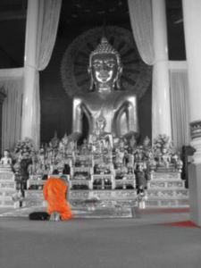 Monk in front of Bhudda image at Wat Phrah Singh