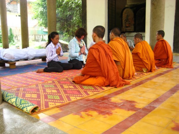 Local monks chanting and praying during the cremation ceremony
