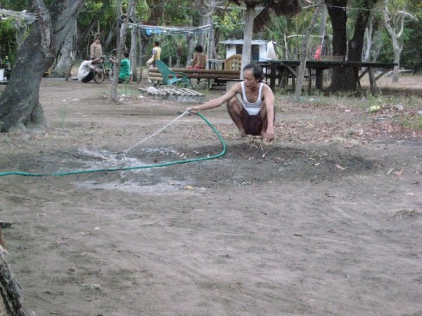 Moyo watering the dirt