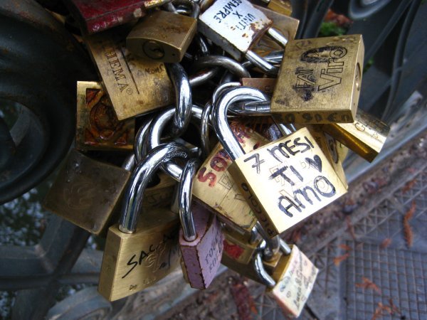 Locks from lovers at a bridge in Milan