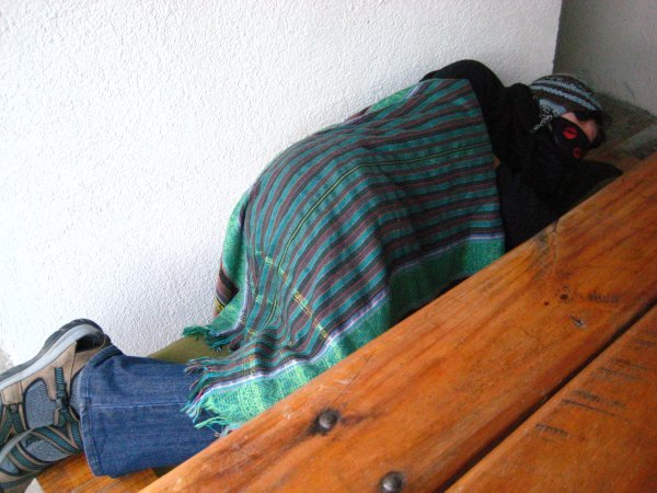 Life of a backpacker: sleeping on a bench after an overnight bus ride.