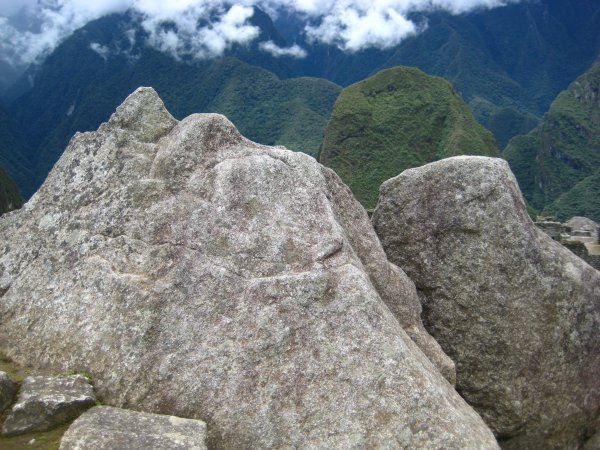 Carved rocks at Machu Picchu resemble the mountains in the background