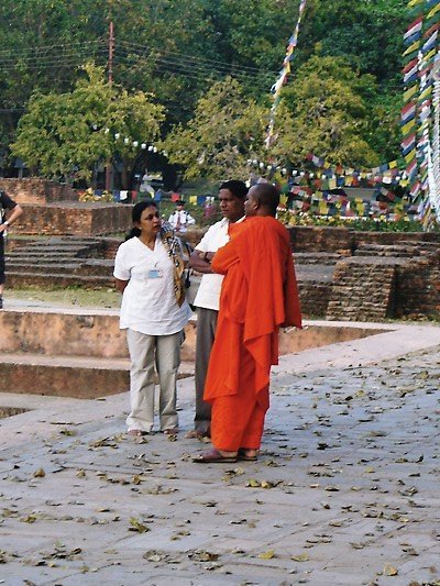Buddhist monk chatting with visitors