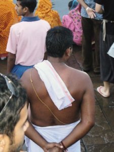 Brahmin man waiting to bathe in the holy Ganges 