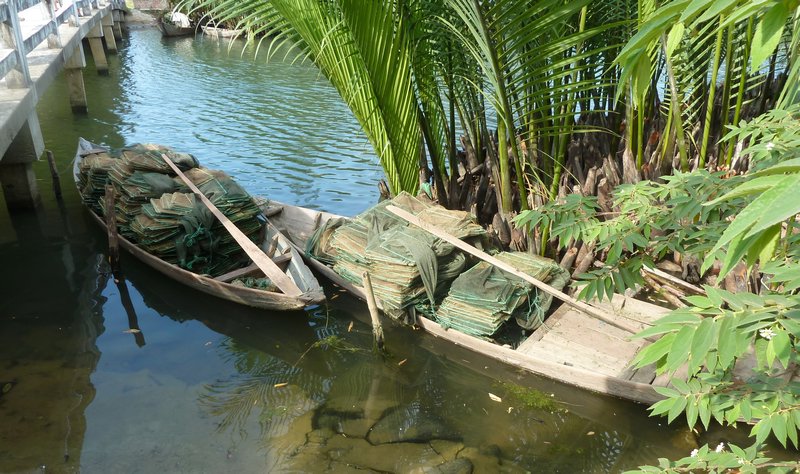 Canoes moored up near a little bridge