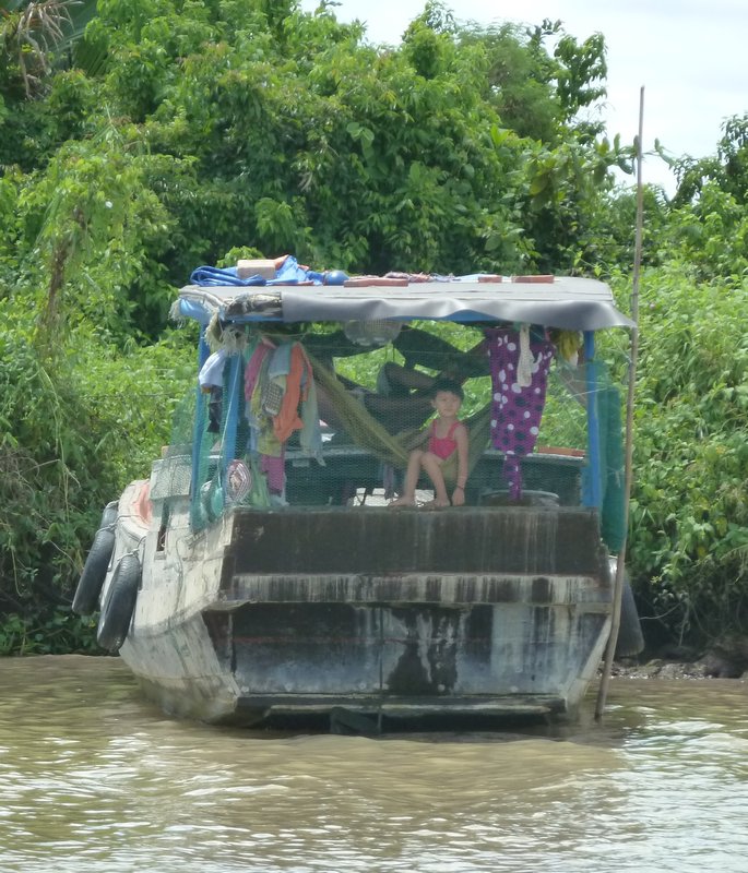 Little girl on her boat, Mekong Delta