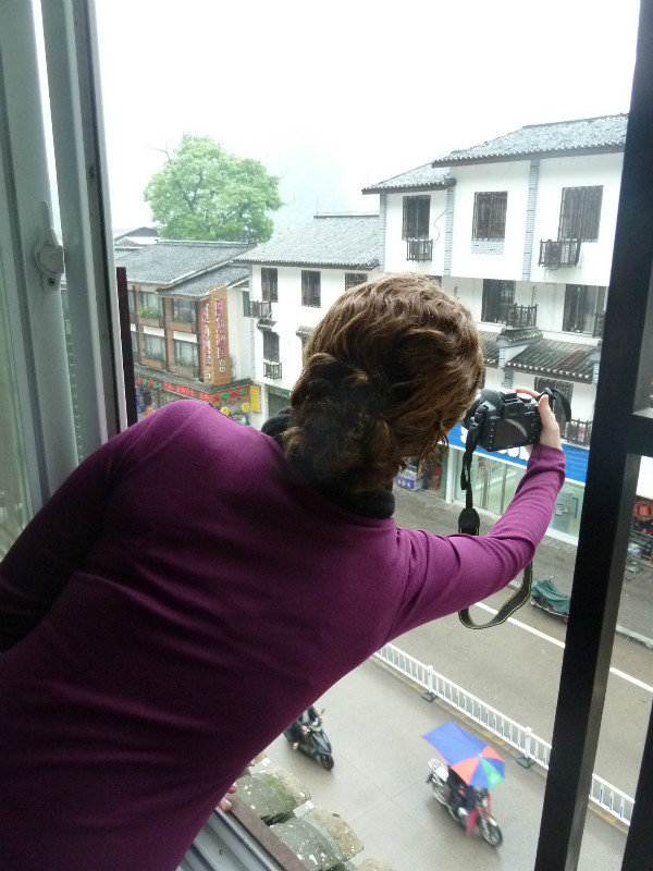 Renee snapping a shot from our hotel room window in Yangshuo