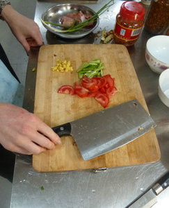Over the top cleaver to chop up tomatoes, chillies and ginger