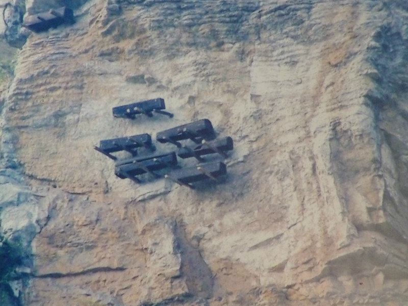 How the coffins are hung up on pegs sticking out of the rock face