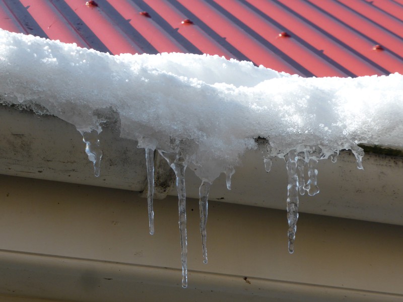 Icicles dripping down from the guttering glistening in the sunlight