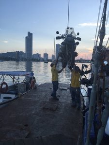 Lifting the bikes off the boat onto barge