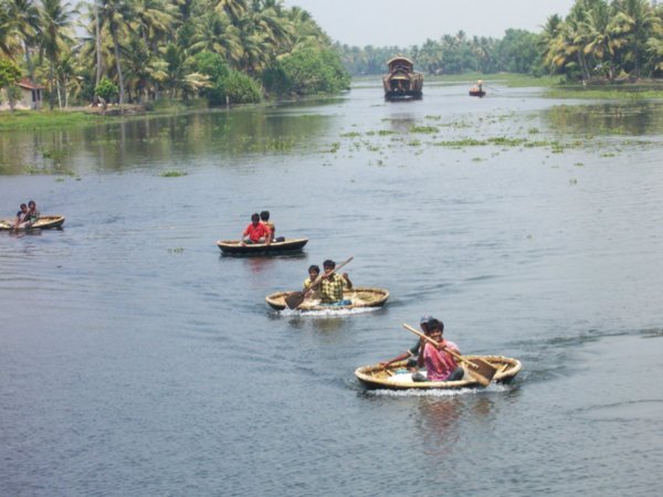 Coracles following ferry on the way to Kollam