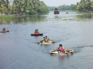 Coracles following ferry on the way to Kollam
