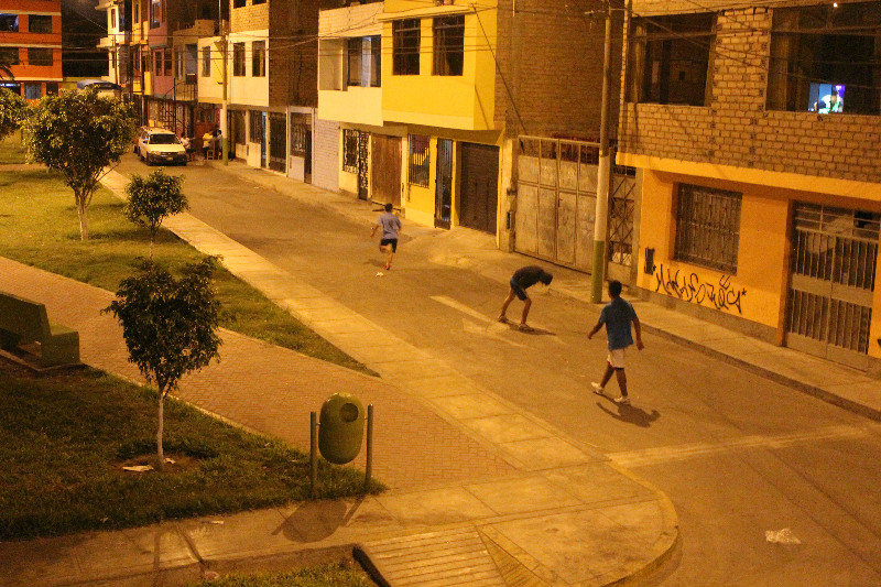 Kids playing soccer in the street