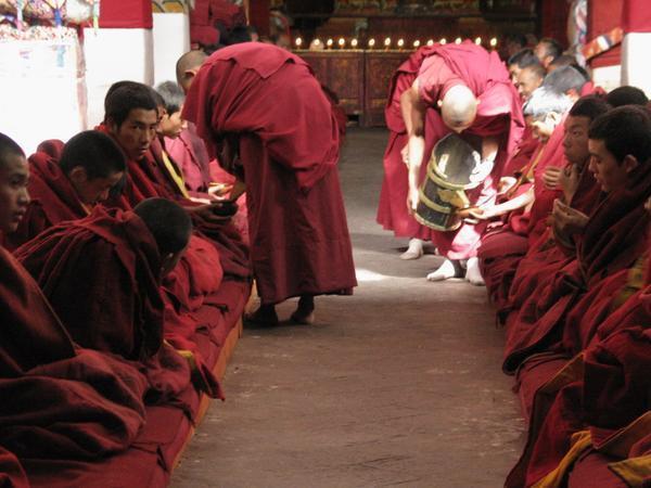 monks having yak butter tea