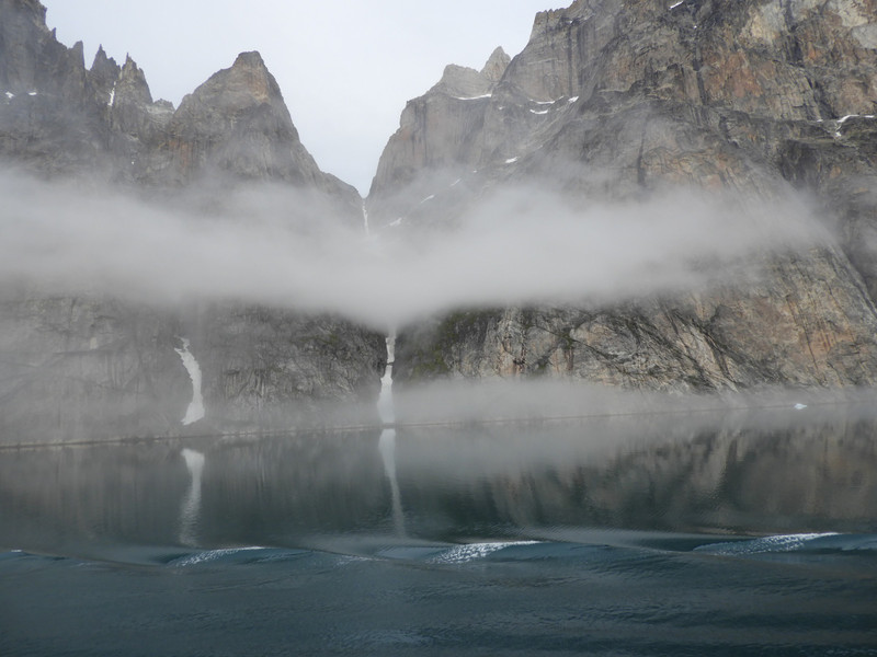 reflection of fog and mountain in the water