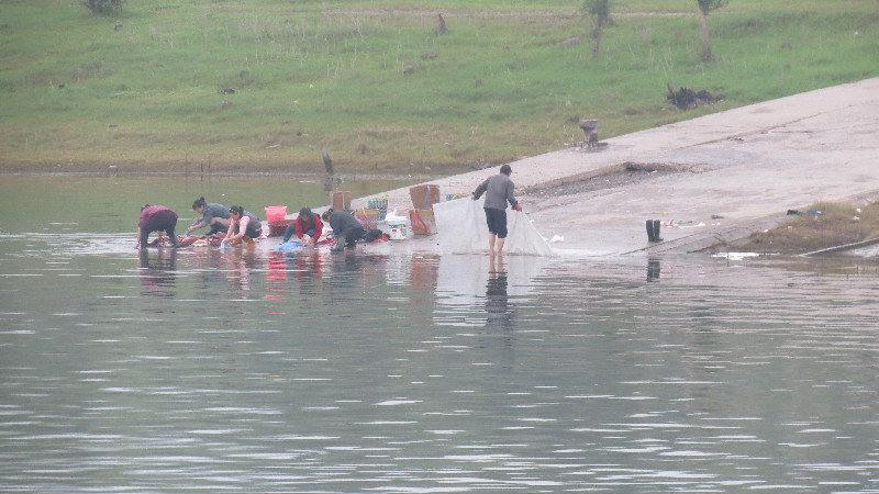 Locals washing the clothes in the river