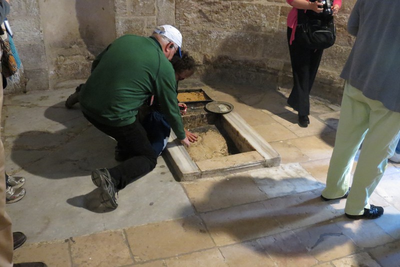 Touching the stone that Jesus ascended to heaven on