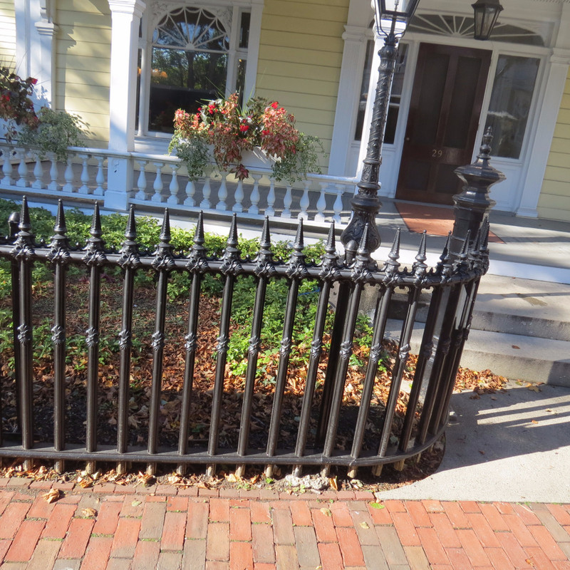 Fence on old house in Newport that is made out of Wood but looks like rod iron