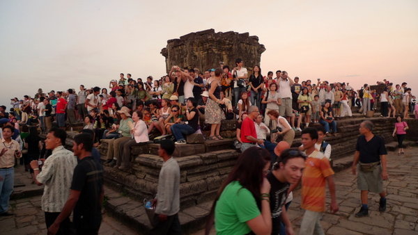 People at the temple at sunset