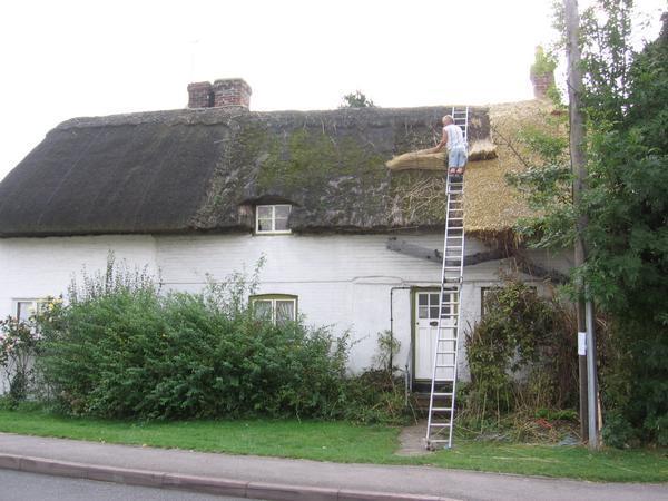 A Man Redoing his roofing.