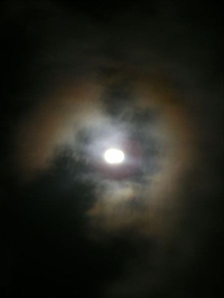 A rainbown circle around the full moon