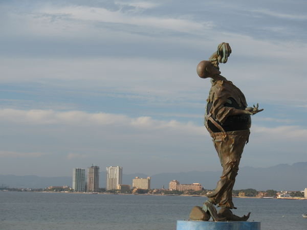 A sculpture along the Malecon with a view of Nuevo Vallarta