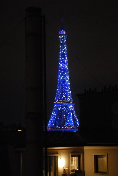 View of the Eiffel Tower lit up at night from our hotel room