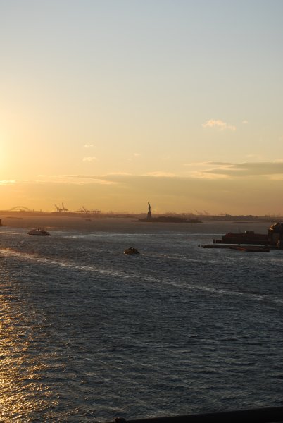 Statue of Liberty in the distance from the Brooklyn Bridge