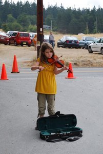 A little girl playing the violin at the Bayview Farmer's Market in Freeland