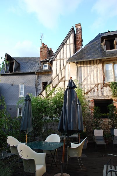 Outdoor dining area at La Cour Sainte Catherine in Honfleur