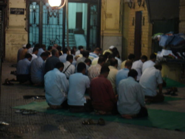 Men kneeling in prayer 