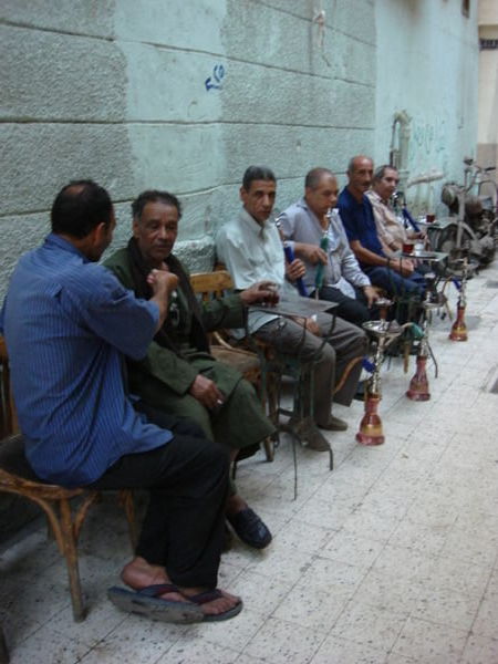Men drinking tea and smoking hookas together
