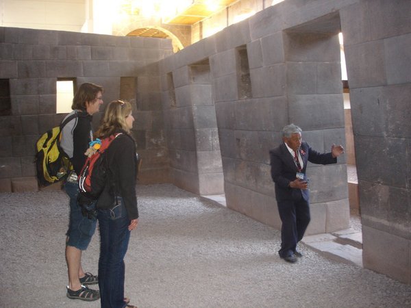 Our cute little guide at Qorikancha enthusiastically points out an Inca wall 