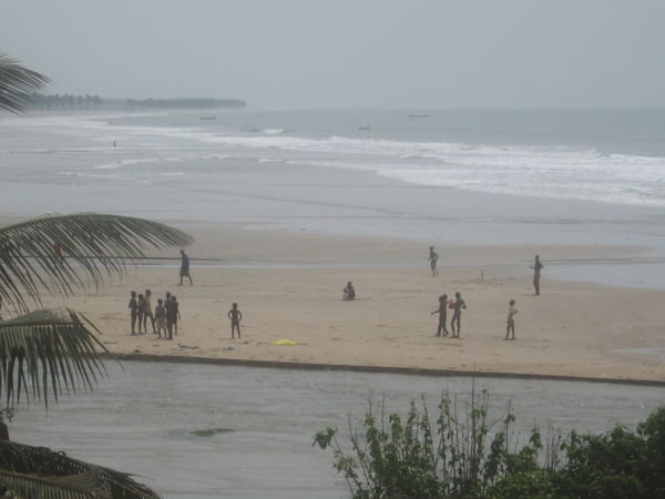 kids playing football on the beach
