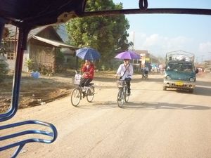 LAOS: Vang Vieng - An umbrella is not always used for rain
