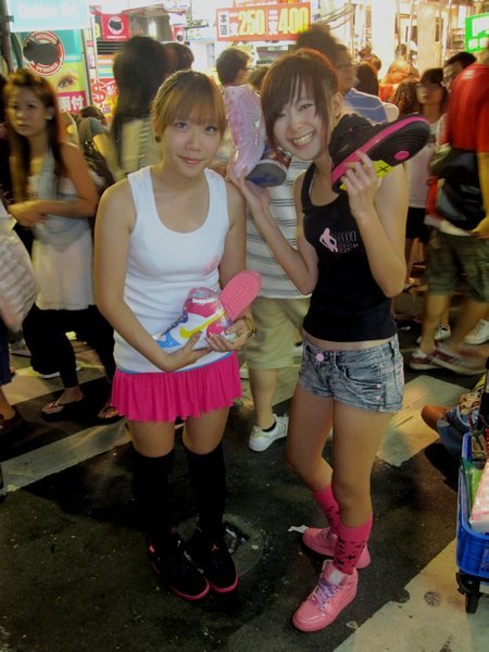Funky sales promoter girls at Shilin night market