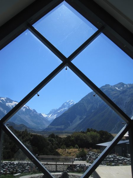 Mt. Cook seen through the windows of the visitor centre in the village