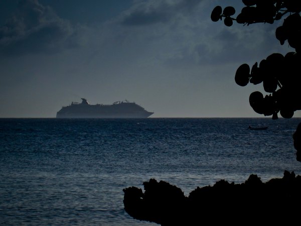 Cruise ship sailing into the sunset on Roatan