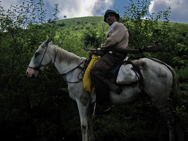 Ranger with gun on horse on volcano El Hoyo